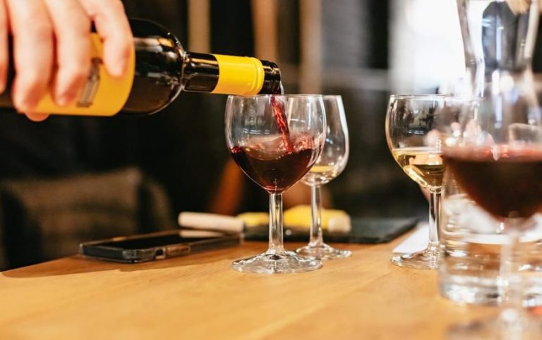 Amsterdam Cheese and Wine Tasting Delight: Red wine being poured into a glass at a tasting event. Gay travel experience.
