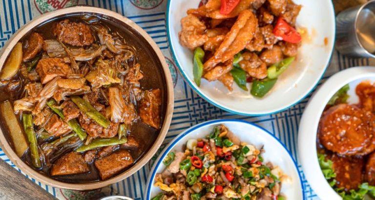 Hanoi Bites food tour: Assorted dishes, including Beijing food, local tastings, and beer, perfect for gay men's travel adventures.