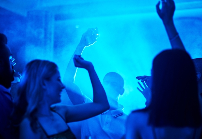 People dancing in a Las Vegas nightclub with blue lighting. Best gay Las Vegas nightclubs schedule, when to party in Vegas.