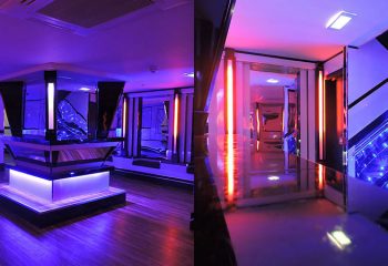 Interior of BJ's White Swan gay club. Bar, stage, and hallway with neon lighting. Gay travel advice. BJs-White-Swan-Gay-Club.jpg