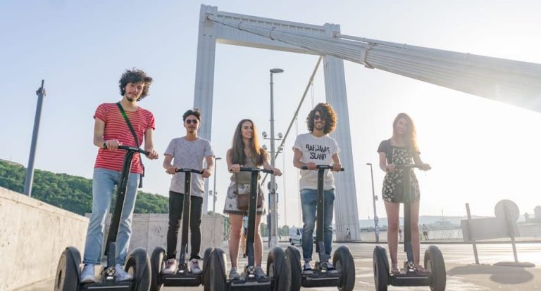 Gay-friendly Budapest Segway tour. Group of friends having fun on Segways with a bridge in the background. Historic vibes in Budapest.
