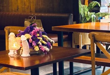 Krubb Bangkok decor: Table centerpiece with phallic objects, flowers, and a candle. Gay travel advice, unique design. c9910f_851a62cabfd74b02a0514abb5da33174mv2