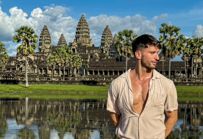 Gay traveler Nico at Angkor Wat, Siem Reap, Cambodia. Shinta Mani Angkor hotel getaway. Colorful Cambodian travel adventure.