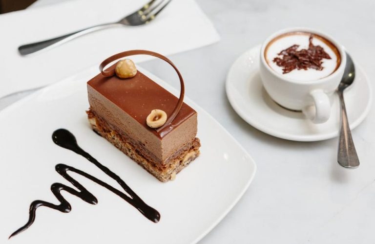 Melbourne's decadent chocolate walking tour: A rich chocolate hazelnut cake with sauce, plus a cup of hot chocolate. Perfect for gay travelers!