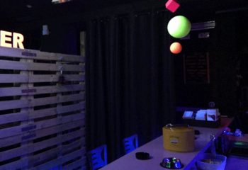 Interior of Copper Private Club, a gay cruising bar in Benidorm. Pallet wall, bar, and hanging decor create a unique atmosphere.