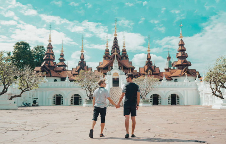 Gay couple holding hands at Dhara Dhevi, a gay-friendly hotel in Chiang Mai, Thailand. Travel advice for gay men.