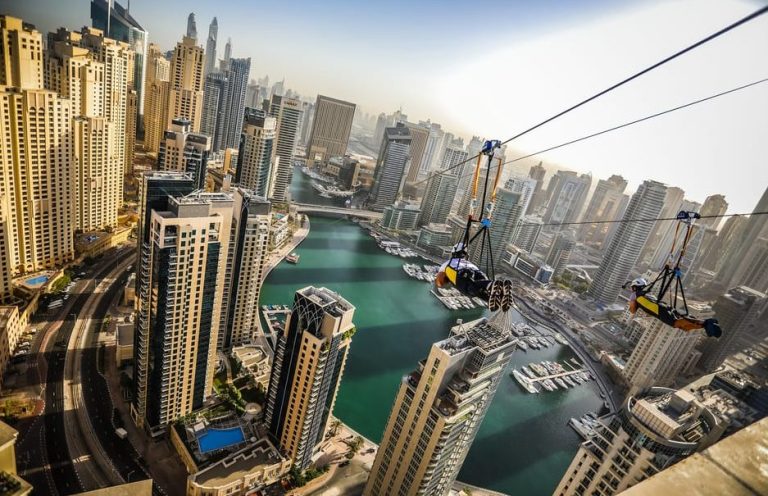 Dubai zip line adventure over the Marina. Thrilling ride with city views. Gay travel advice for exciting experiences.