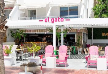 El Gato Lounge gay bar in Torremolinos. Outdoor seating area with pink chairs and tables. A popular gay travel destination in Spain.