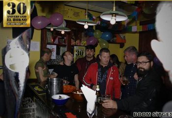 Interior of El Horno Gay Bar in Sitges, Spain. Gay men at the bar, celebrating 30th anniversary. Gay travel advice, nightlife.