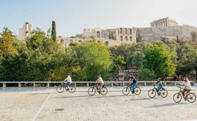 Electric Bike Tour of Athens Old Town. People biking near the Acropolis. Gay men travel adventure, exploring hidden gems.