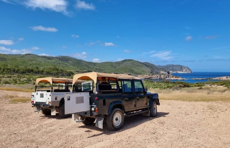 Ibiza Jeep Safari: Two open-top jeeps ready for adventure. Scenic views of the coast, perfect for gay travel exploring hidden gems.