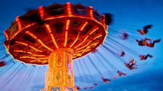 A photo of an amusement park ride where riders rotate on swings.