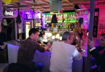 Habrolo Cafe Bar Budapest interior. Gay bar scene with men at the counter. Budapest gay travel advice.