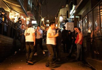 Homo Hill Seoul, Korea LGBT party street in Itaewon. Gay men at night, socializing outside bars and clubs. Seoul's vibrant gay nightlife.