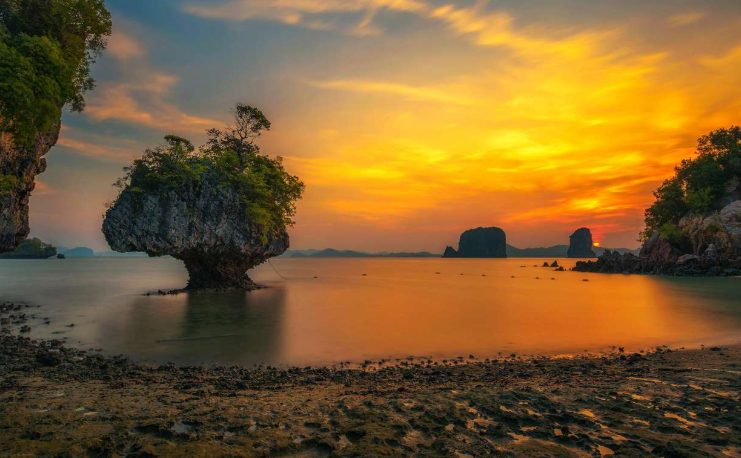 Sunset at Hong Island, Ko Pak Bia, Thailand. Gay travel escape with BBQ bliss. Golden sky reflects on the calm water. Tropical paradise.