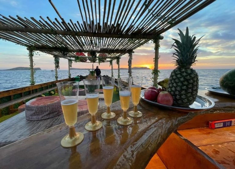 Ibiza sea caves snorkeling & paddleboarding tour. Champagne & fruit on boat at sunset. Gay men's travel adventure on the West Coast.