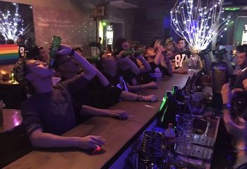 Iblue Bar & Cafe Kuala Lumpur gay night life. Men & women drinking beer at the bar. Popular gay nightlife in Kuala Lumpur, Malaysia.