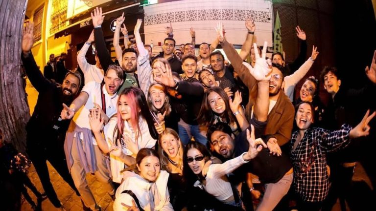 Enthusiastic group at Istanbul's gay-friendly party pub crawl. Wild nights, rooftop vibes, and party bus fun for gay travelers.