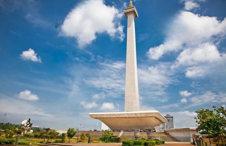 Jakarta Highlights Day Tour: Monas monument against a blue sky. LGBTQ-friendly cultural travel in Indonesia.
