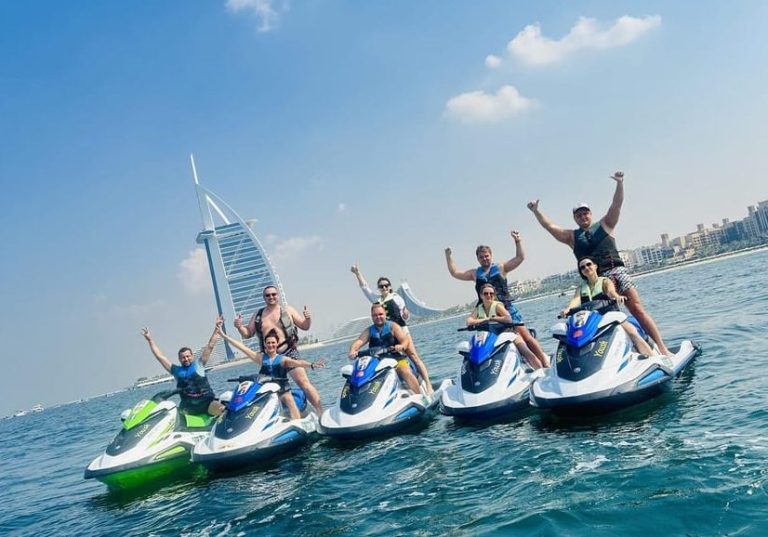 Gay travelers on a jetski adventure in Dubai. Burj Al Arab view. Ride the waves, explore iconic landmarks, and create unforgettable memories.