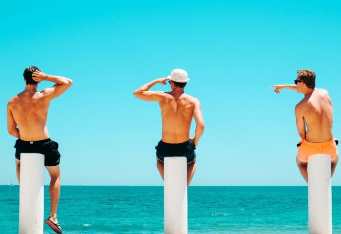 Gay Benidorm Travel: Three men on a beach. Bengs photo of men enjoying the sun and sea. Travel guide for gay men in Benidorm, Spain.