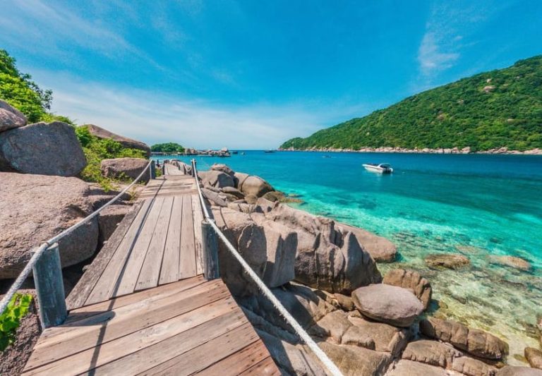 Koh Pha Ngan & Koh Tao tropical snorkel escape. Wooden path to turquoise waters, rocks, and lush island. Gay travel adventure.