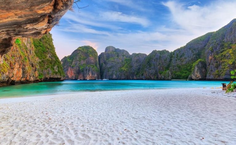 Phi Phi Island sunset snorkeling tour. Krabi's ultimate island escape. White sand beach, turquoise water, and limestone cliffs.
