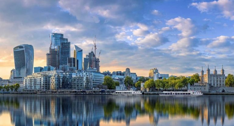 London skyline from a River Thames cruise, Tower of London, Greenwich view. Gay travel to London, UK.