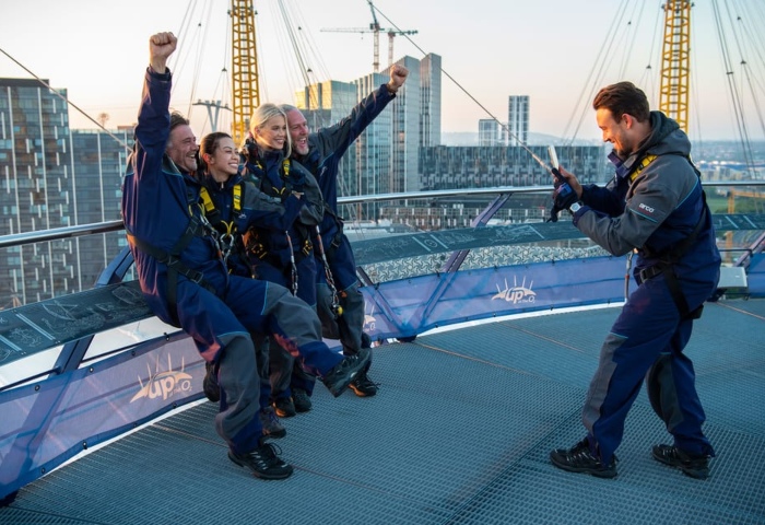 Gay travel: People climbing on the roof of London's O2 Arena. The rooftop climbing experience is one of the top things to do in London.