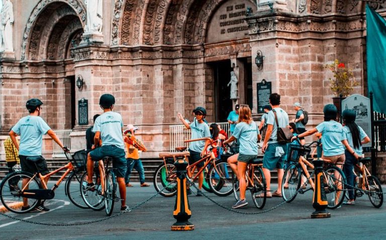 Manila Intramuros bamboo bike adventure tour group in front of a building. Gay travel advice for exploring the Philippines.