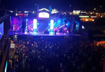 Gay club Mantrix in Gran Canaria. Night view of a crowded outdoor concert with stage lights and a band performing for gay men.