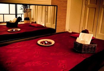 Madrid gay massage. Red massage beds with candles & towels. Relaxing spa at Majestic for gay men traveling in Madrid, Spain.