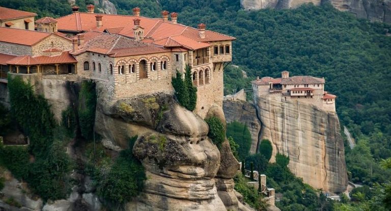 Meteora day trip: Monasteries atop rock pillars, a majestic sunset view. Travel Athens to see this unique landscape.