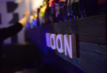Moon Bar in Shanghai. Bar shelf with bottles and MOON sign. Gay travel nightlife in Shanghai. Gay bars, gay clubs.