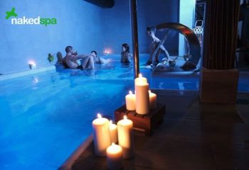 NKD Spa Gay Cruise Club in Madrid: Men enjoy a relaxing spa experience with candles and blue lighting. Gay travel advice.