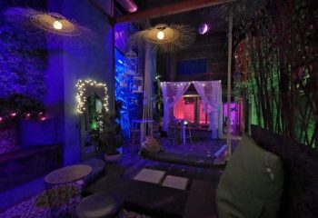 NKD Spa Gay Cruise Club in Madrid: Relaxing space with ambient lighting, seating, plants, and decorative elements for gay travelers.