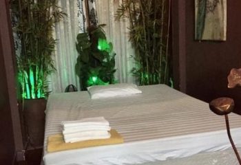 Polar Spa Hanoi treatment room. Massage bed with towels, pillow, and bamboo decor. Gay travel in Vietnam. Relaxing atmosphere.