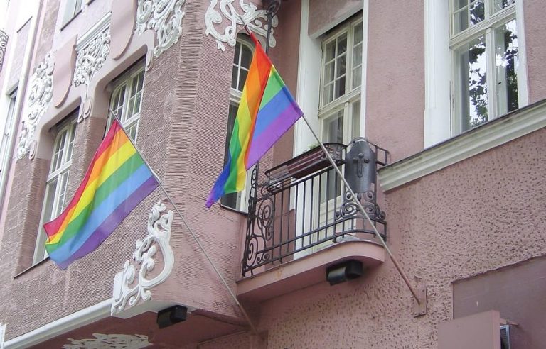 Building with rainbow flags in Berlin. Explore the gayborhood and LGBTQ history of the capital with a queer walking tour.