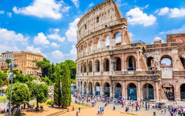 Rome Colosseum tour: Ancient amphitheater view, blue sky, tourists. Skip the line for gay travel adventures in Italy.