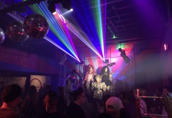 Scarlet Honolulu gay bar drag show. Drag queens perform on stage under colorful lights. Nightlife scene in Honolulu, Hawaii.