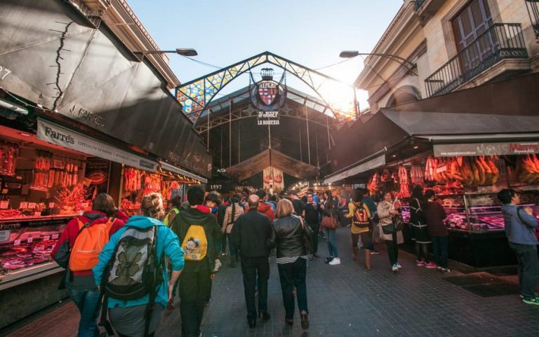 Boqueria Market in Barcelona, Spain. A paella cooking class is a must. Seafood, sangria, and sizzle await gay travelers.
