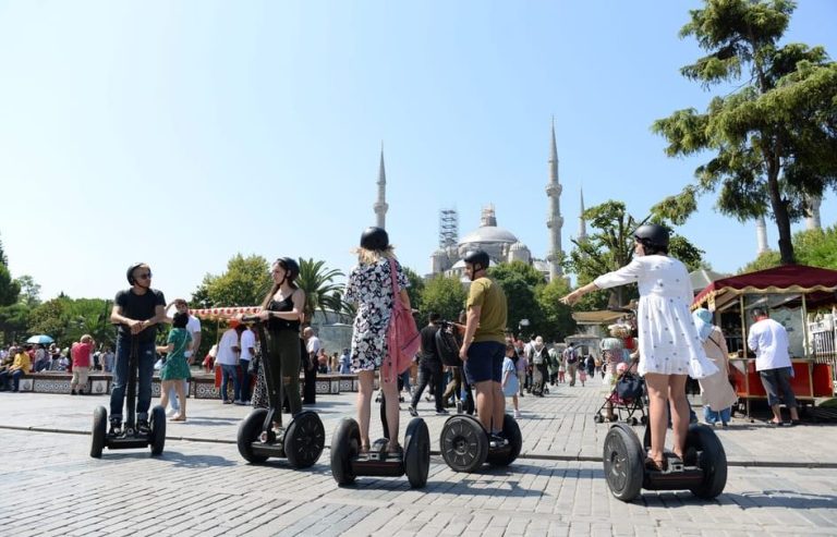 Gay-friendly Segway tour in Istanbul's historic old town. Tourists ride Segways near the Blue Mosque, enjoying the sights.