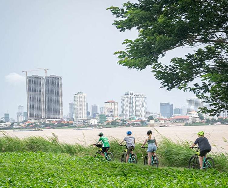 Gay-friendly Hanoi tour: Group biking on Silk Islands. Countryside escape with city skyline view. Half-day adventure, bites & train street vibes.