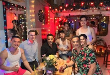 Space Hair Salon and Bar, Phnom Penh: A group of gay men at a bar in Cambodia, enjoying drinks and the vibrant atmosphere. Gay travel.