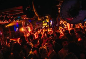 Sub 101 Manchester: A packed gay club scene with dancing men under vibrant lights. A lively night out in Manchester's gay village.