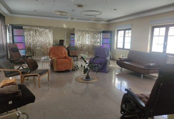 Lounge area at a Thai Holistic Massage spa in Gran Canaria. Relaxing space for gay men's wellness, featuring chairs and a couch.