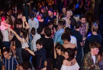 Inside The George Gay Club Dublin: a crowded dance floor with people dancing, socializing, and enjoying the vibrant atmosphere.
