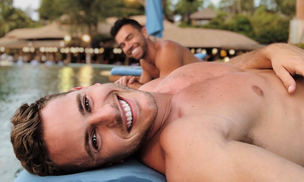 Two gay men smiling at The Naka Island, a Luxury Collection Hotel, Phuket. Popular gay hotel for gay travel advice.
