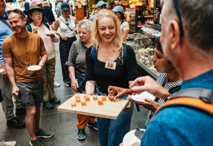 Copenhagen Bites & Sips food tour. People sampling food. Top gay things to do in Copenhagen, Denmark. Gourmet food tasting.