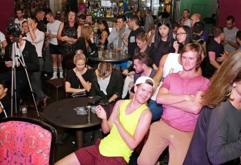 Crowded bar scene in Sydney, Australia. Gay travel destination with diverse patrons, drinks, and a relaxed atmosphere. Nightlife.